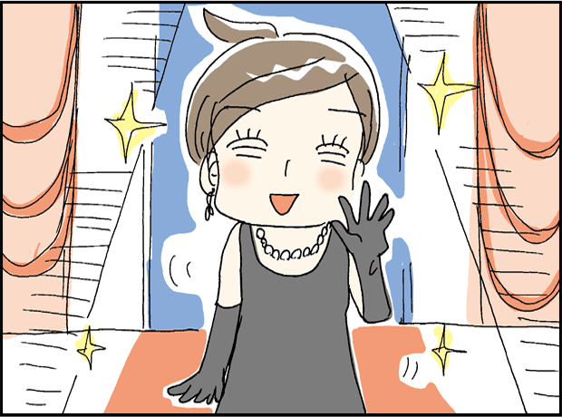 ドレス姿の主人公が、審査員としてアワードの会場に登場する場面